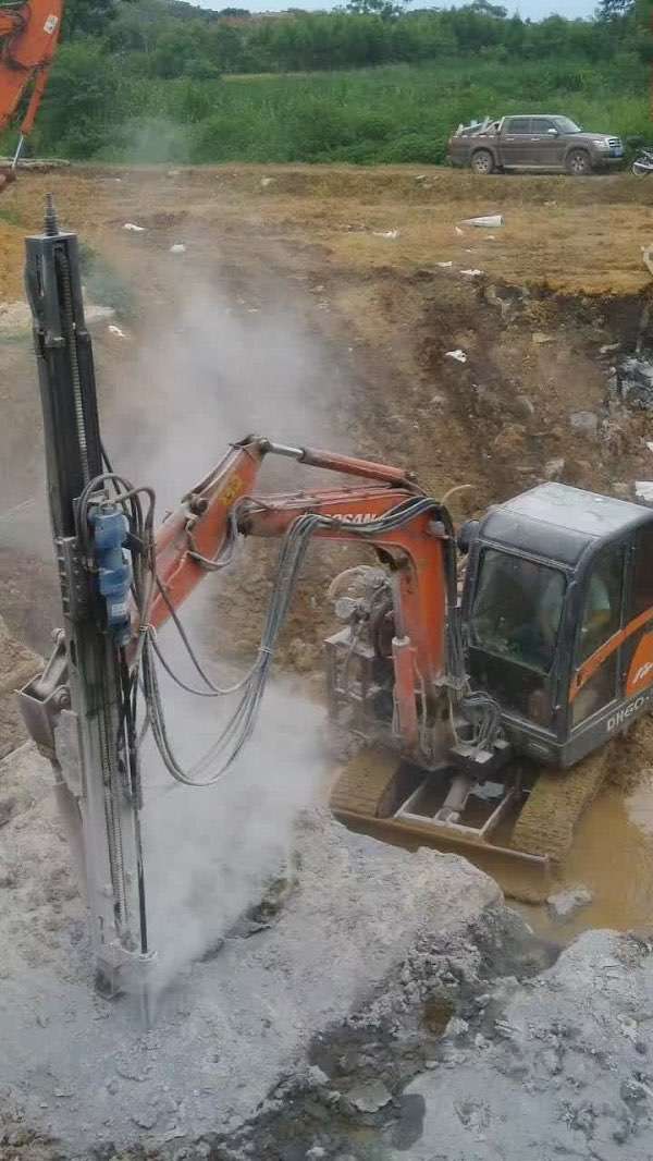 Excavator Mounted Rock Drill at work site